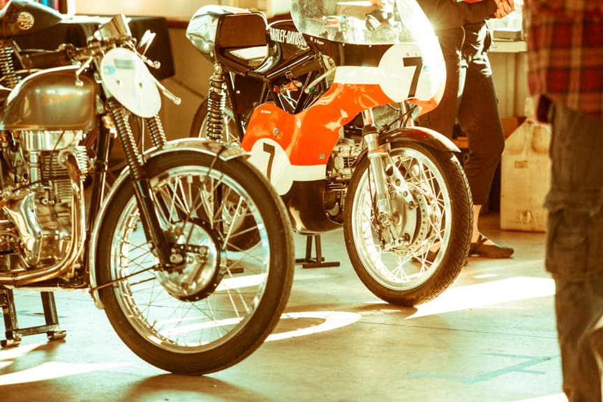 An image of a cool looking vintage Harley Davidson motorcycle with an orange colour fairing and the number seven on the front.