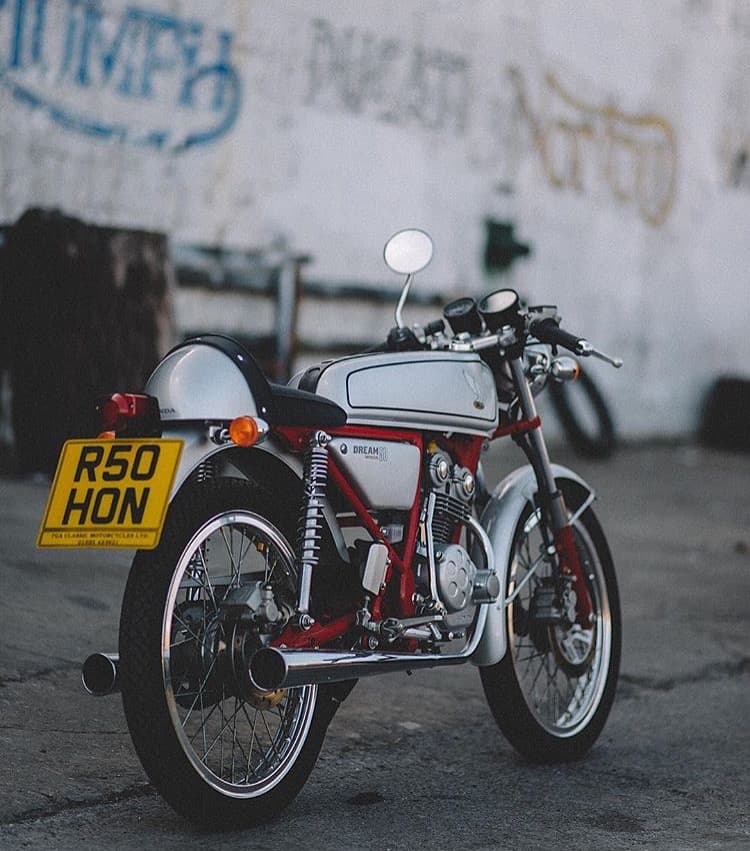 An image of a silver 1997 Honda Dream 50 with red frame