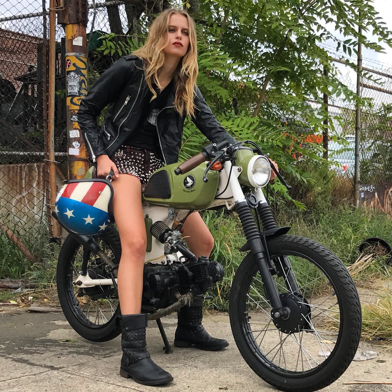 An image of an olive green 1970 Honda SS CL90 being ridden by a lady in a biker jacket