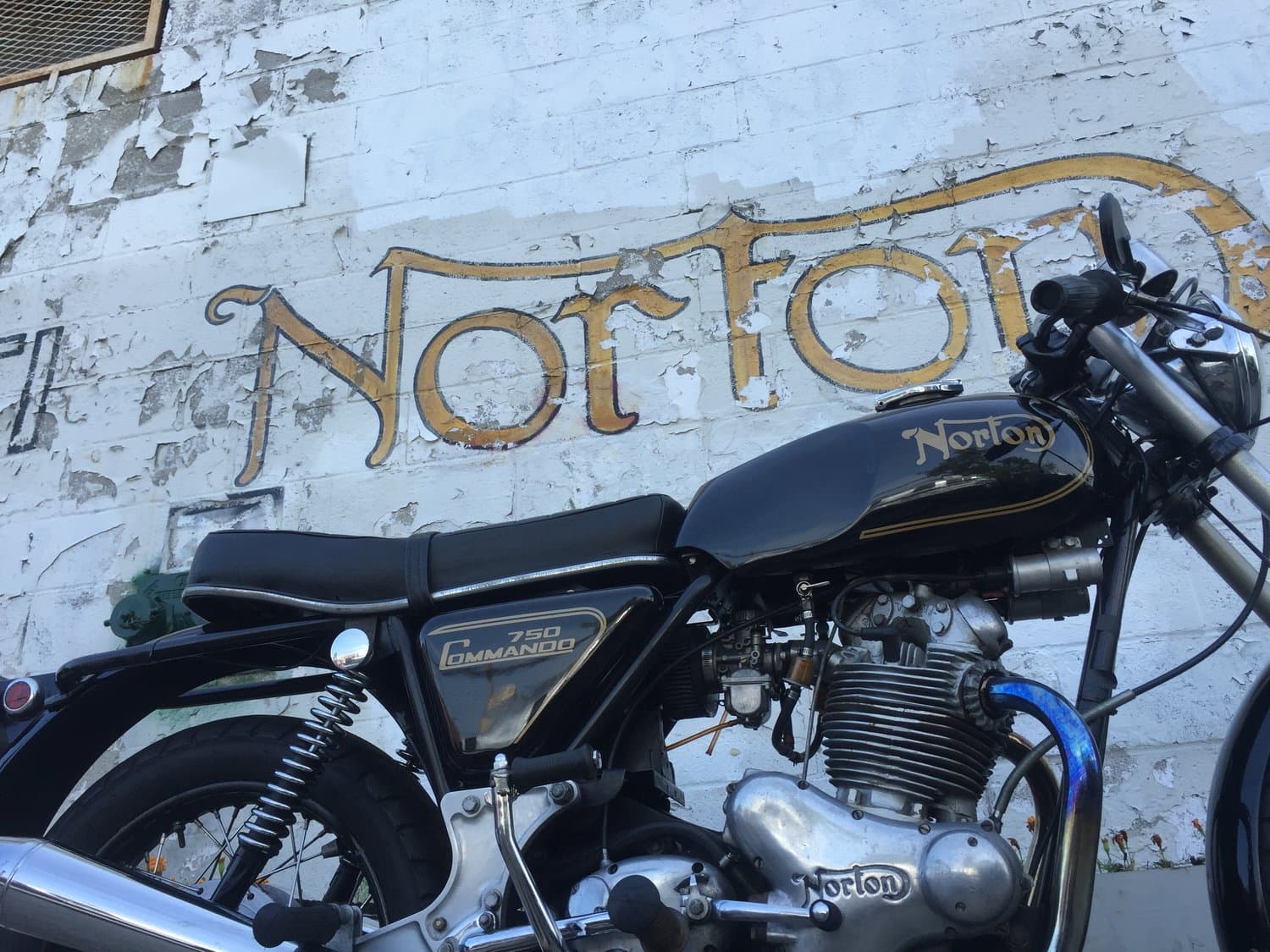 An image of a black 1970 Norton Commando with gold trim