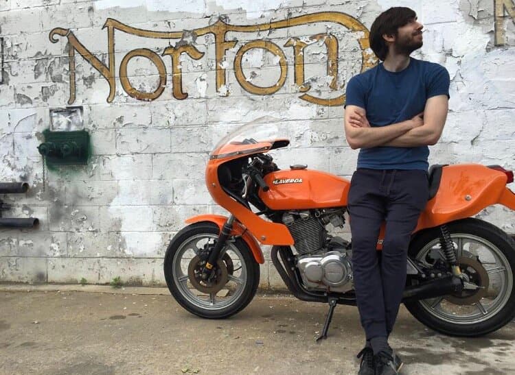 An image of a David Karp, the founder of Tumblr leaning on an orange coloured Laverda motorbike outside the New York City Motorcycles showroom.