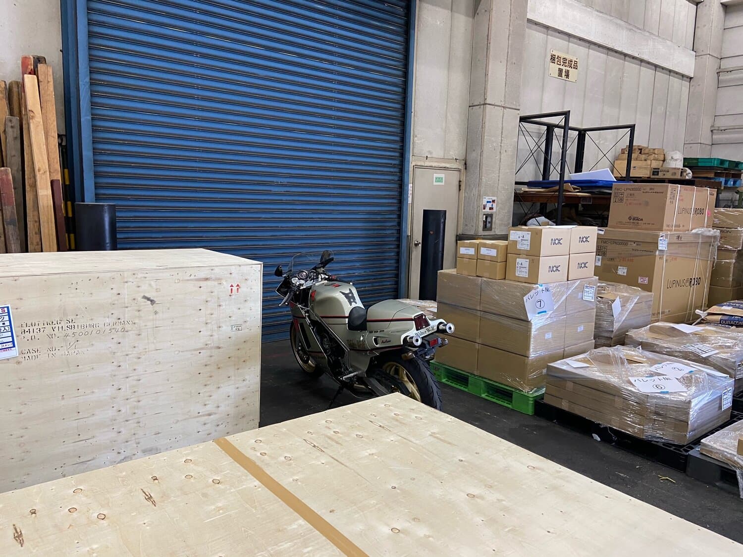 An image of a 1985 Suzuki WW RG400 awaiting collection from customs in Japan.